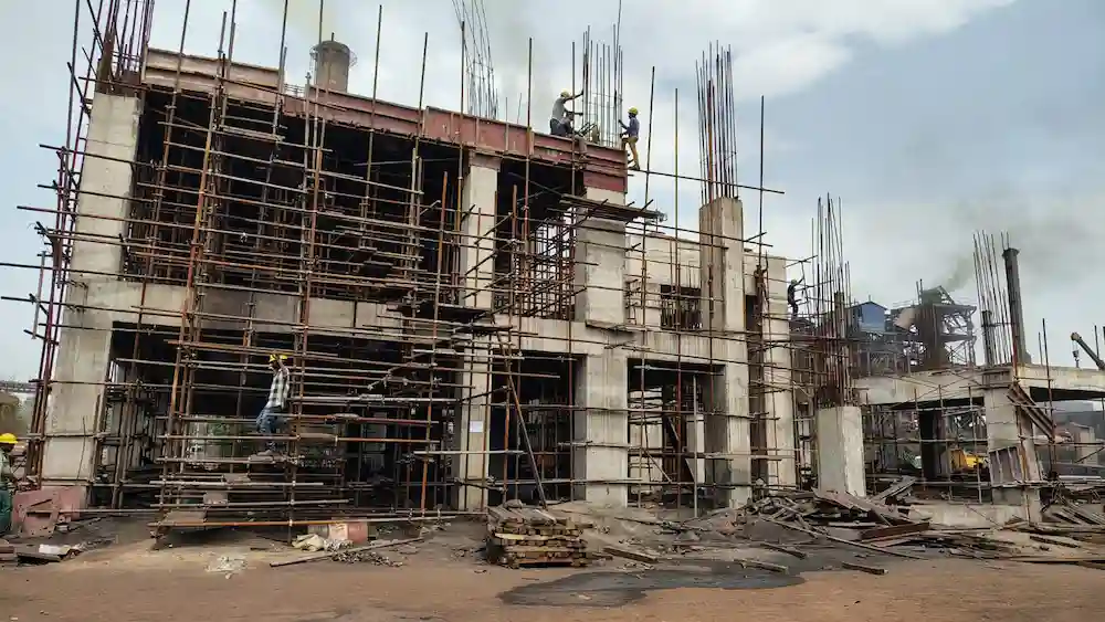 Industrial power plant construction site with heavy cranes showcasing foundation design and structural planning.